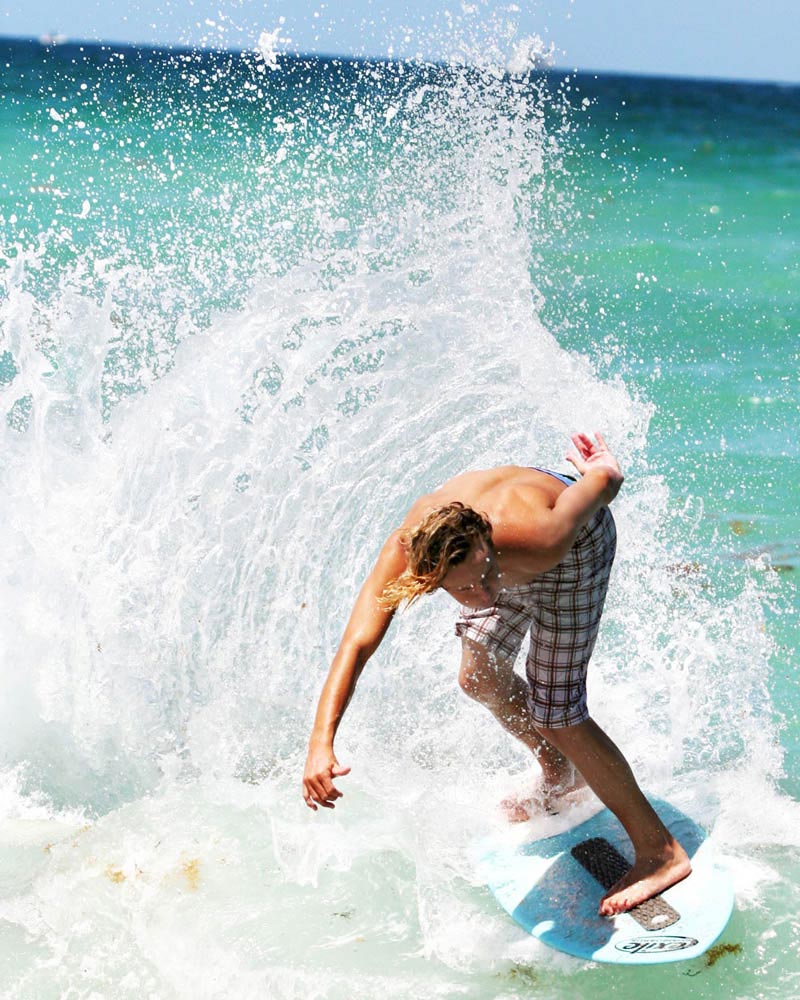 skimboarder with grip placed at the back and middle of board